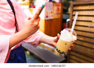 Young Girl Take A Photo Of Trendy Drink ( Named Tapioca Milk Tea )