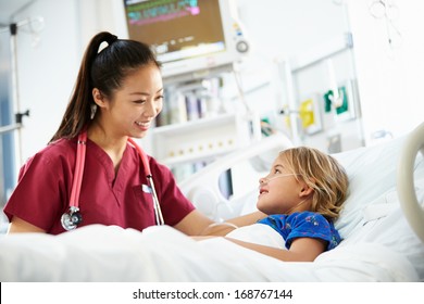 Young Girl Talking To Female Nurse In Intensive Care Unit