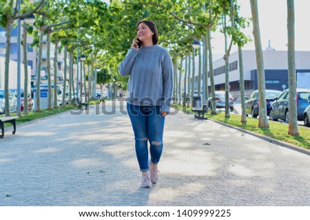 young girl talking on smartphone and typing messages with smartphone