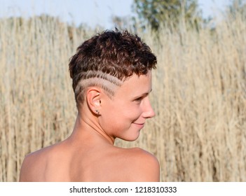 Young Girl With Tanned Skin With An Undercut Haircut And Shaved Strips On Her Head