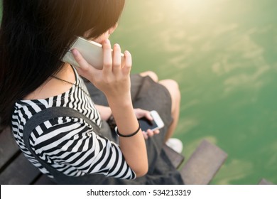 Young Girl Teen Use Smart Phone In One Hand To Talk And Other Hand Holding Once. The New Generation Do Not Miss Contact, Communication And Lost Power.