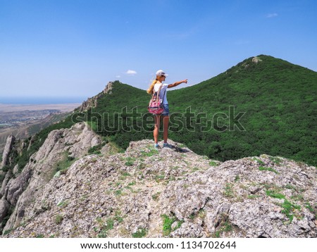 Young girl at the top of the mountain