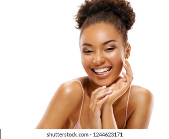 Young girl touching her healthy skin. Photo of smiling african american girl on white background. Youth and skin care concept