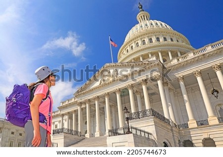 Young girl tourist admiring the US Capitol in Washington DC, USA