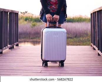 Young Girl With Travel Suit Case On The Wooden Bridge Background