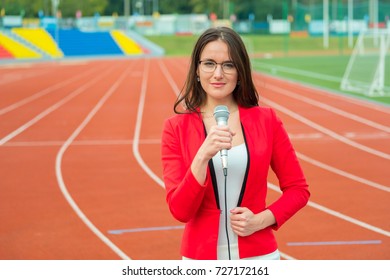 Young Girl TV Reporter Is Broadcasting From Stadium