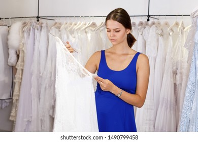 Young girl upset about the high price of wedding dress in wedding salon