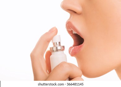 Young Girl Using Breath Freshener.