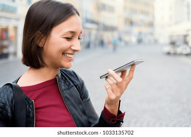 Young girl using vocal assistant on smart phone - Powered by Shutterstock