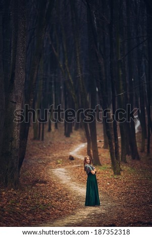 Similar – Image, Stock Photo Young woman with hat taking a walk in the deep forest at sunset.