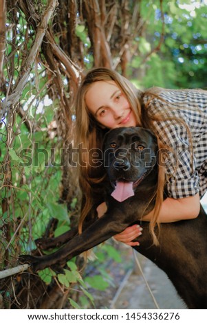 Similar – Pretty blond woman with her two dogs