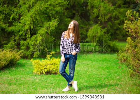 Similar – beautiful young woman smiling while walking in the park