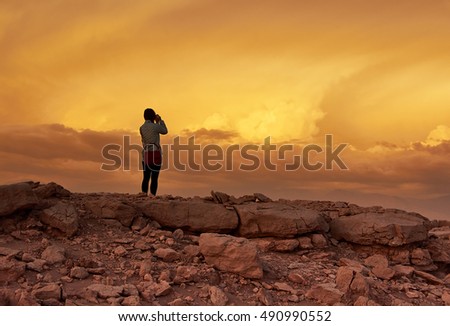 Young girl watching a marvelous sunset on the eve of the storm                        