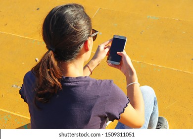 Young Girl Watching Smart Mobile Phon