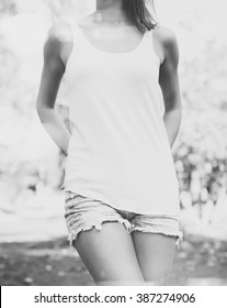 Young Girl Wearing Blank Long Vest T-shirt. Outdoor Background. Horizontal Mockup, Blurred, Bokeh Effect. Black White Photo