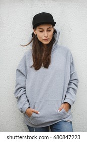 Young Girl Wearing Blank And Oversize Long Hoodie And Black Cap. Outdoors Lifestyle Portrait