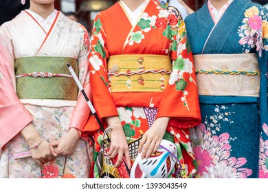 Young girl wearing Japanese kimono standing in front of Sensoji Temple in Tokyo, Japan. Kimono is a Japanese traditional garment. The word "kimono", which actually means a "thing to wear" 