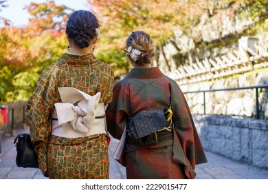 Young girl wearing Japanese kimono standing  in Kyoto, Japan. Kimono is a Japanese traditional garment. The word 