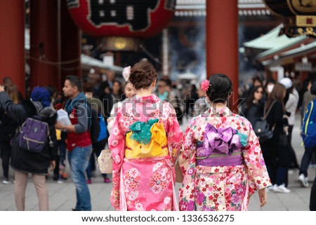 Young girl wearing Japanese kimono standing in front of Sensoji Temple in Tokyo, Japan. Kimono is a Japanese traditional garment. The word "kimono", which actually means a "thing to wear"