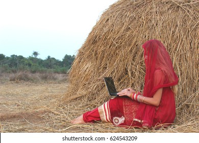 Young girl working on laptope in village.  freelance work concept