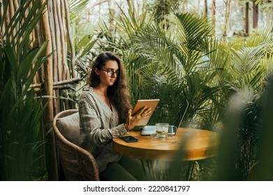 Young girl works on the tablet on the internet and goes to the train, ipad surfing, woman using smartphone, holding tablet in hand, send answer texts, travel in train, office manager, hipster