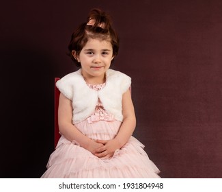 Young Girl In Yearbook Style Portrait Isolated On A Dark Background.