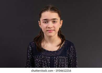 Young Girl In Yearbook Style Portrait Isolated On A Dark Background.