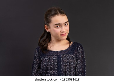 Young Girl In Yearbook Style Portrait Isolated On A Dark Background.