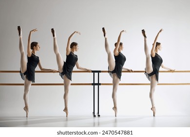 Young girls, ballet dancers showing grace and flexibility, standing next to barre and training, practicing against grey studio background. Concept of ballet, art, dance studio, classical style, youth - Powered by Shutterstock