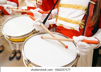 Young Girls Drummers Hands In Red Uniforms And White Skirt With White Gloves Drumming On Drums At Marching Band