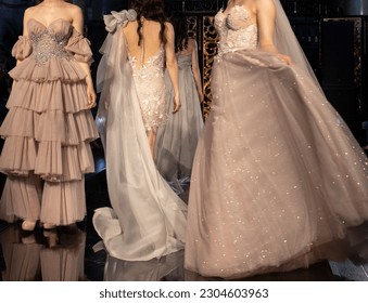 young girls of European appearance demonstrate beautiful designer dresses on the catwalk. Festive haute couture dresses, defile, dress with ruffles, rhinestones, embroidery. Young designers 