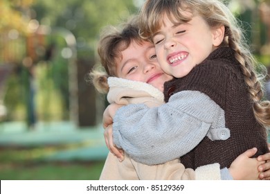 Young Girls Hugging Outside