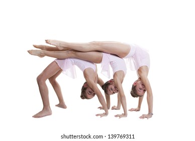 Young Girls Kids Or Children Doing Gymnastic In Gym Class.