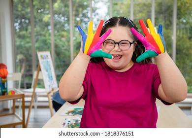 Young girls with learning disabilities Or the group of Down's syndrome is learning about drawing and painting colorful on hand for creative and learning arts. Education special concept.