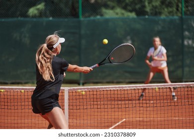 Young girls in a lively tennis match on a sunny day, demonstrating their skills and enthusiasm on a modern tennis court. - Powered by Shutterstock