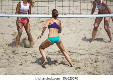 Young girls playing Beach Volleyball in sunny day