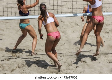 Young girls playing Beach Volleyball in sunny day