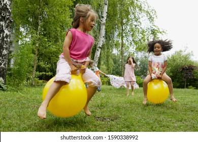 Young girls playing on bouncy balls