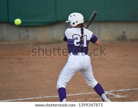 Young girls playing the sport of fastpitch softball
