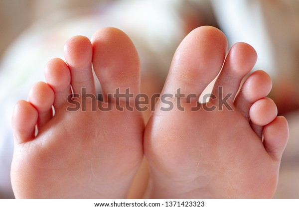 young girl\'s toes are healthy and beautiful.\
Well-groomed toes. Concept for medical articles and ointments - the\
image of the toes and feet. Image of legs with space for\
inscriptions and\
advertising.