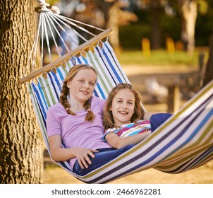 Young, girls and together in outdoor hammock with relax, portrait in nature for bonding and wellness. Friends, vacation or bed in tree with freedom in countryside, England sunset in summer with smile - Powered by Shutterstock