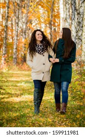 Young Girls Walking In The Autumn Park