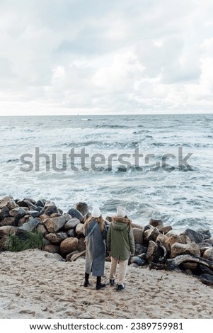 Young girls walks along the shore