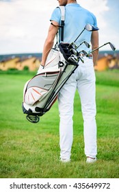 Young Golfer Holding Golf Bag