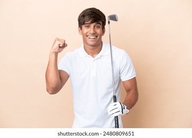 Young golfer player man isolated on ocher background celebrating a victory in winner position - Powered by Shutterstock