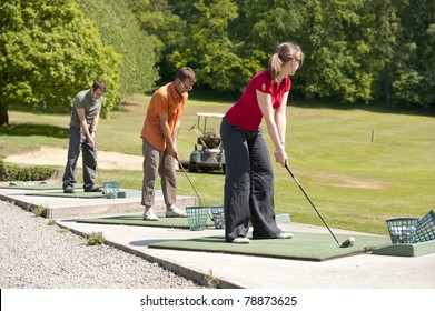 Young Golfers Practising At The Driving Range