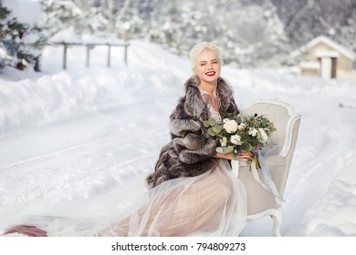 Young Gorgeous Fashionable Woman In Wedding Dress In Stylish Fur Coat Outdoor In Winter