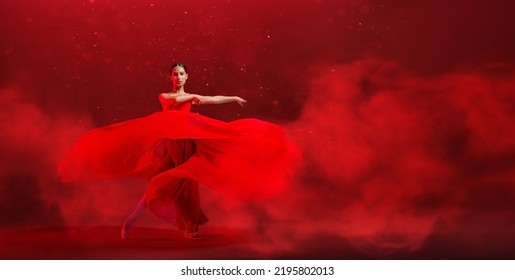 young graceful ballerina, dressed in pointe shoes and a weightless red skirt, demonstrates her dancing skills. The beauty of classical ballet. - Shutterstock ID 2195802013