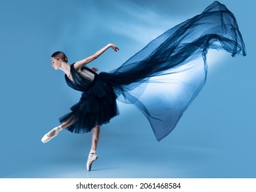 Young and graceful ballet dancer in black stage outfit, dress dancing isolated on white blue studio background in neon light. Art, motion, action, beuaty, flexibility, inspiration concept. - Powered by Shutterstock