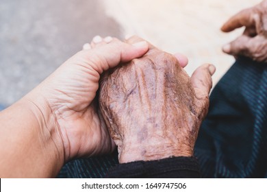 Young grandchildren's holding older grandmother hands feel with love and support together, Care for elderly Helping hands, take care concept.